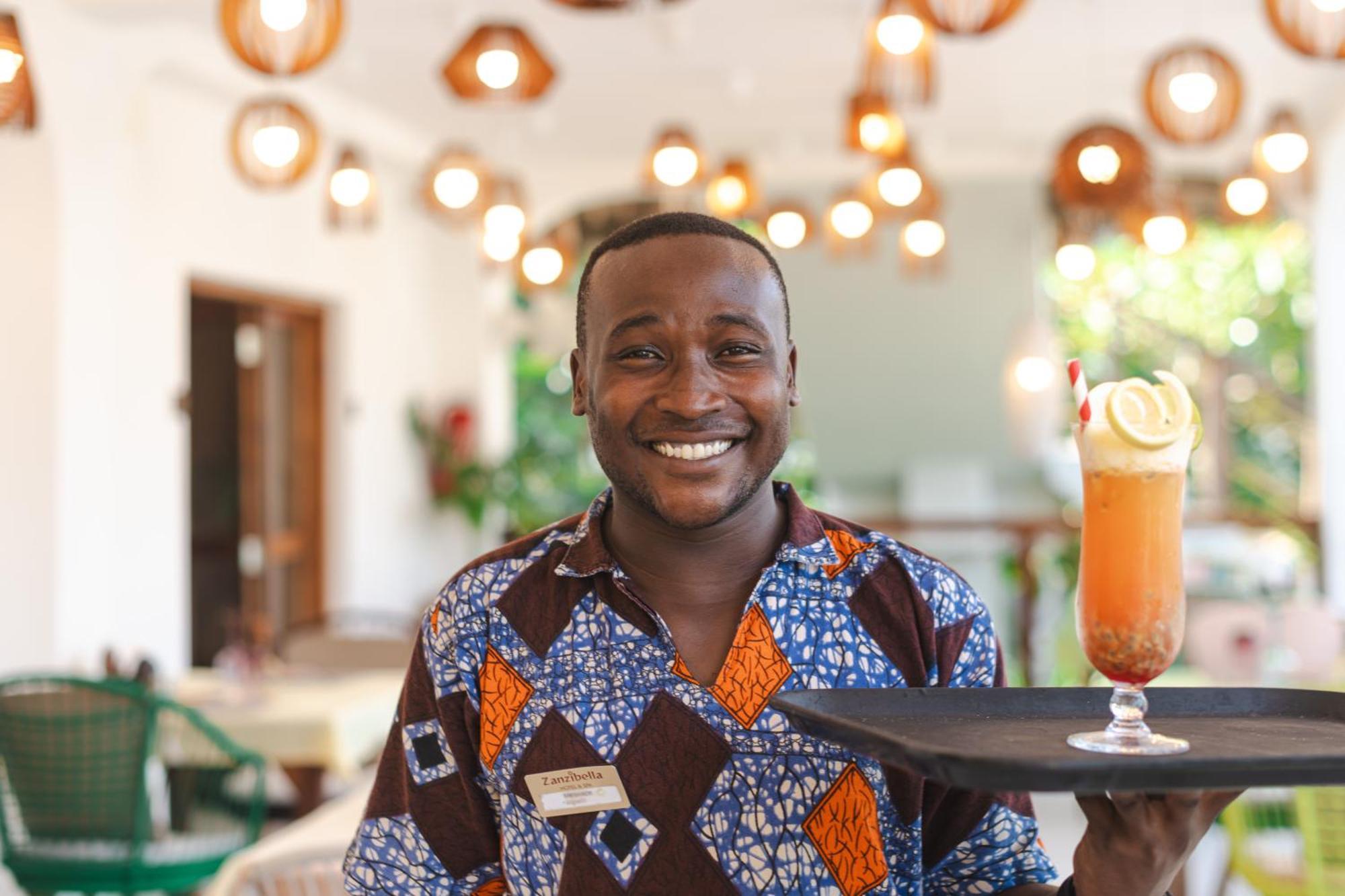 Zanzibella Hotel & Spa 키웬그와 외부 사진 A waiter at the Serena Hotel in Kampala, Uganda